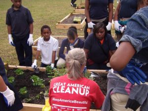 Keep Jackson People teaches Poindexter students about planting fruits and vegetables in the raised beds in the school's new outdoor classroom.